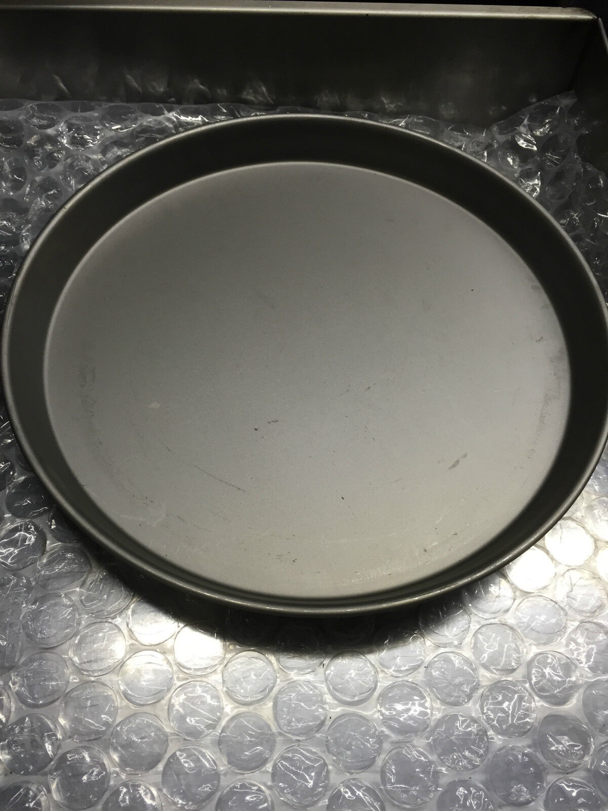 Iron Pizza Pans Set of 10, demonstrating even heat distribution, essential for crispy golden crusts in deep pan pizzas.