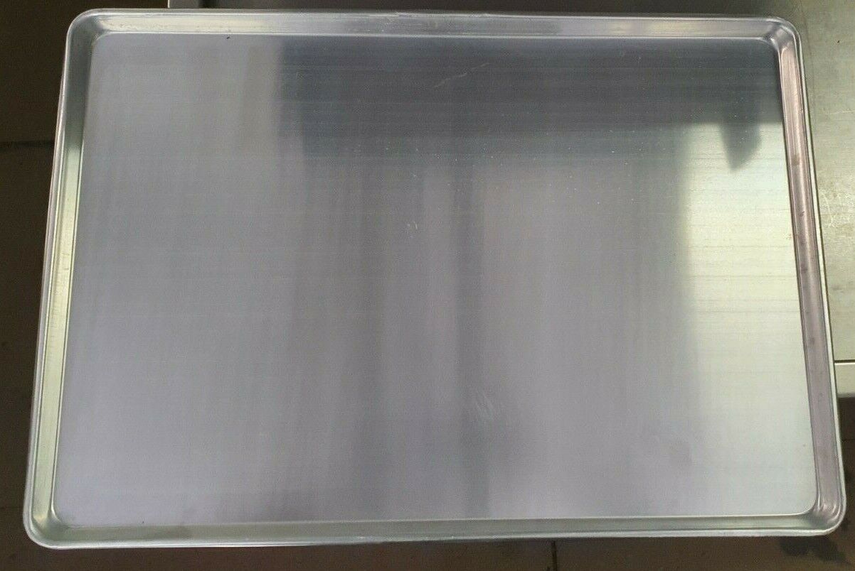 Henny Penny Chicken Tray Sheet Pan 1826 Set of 2 in a commercial kitchen setting, perfect for catering services and food preparation.